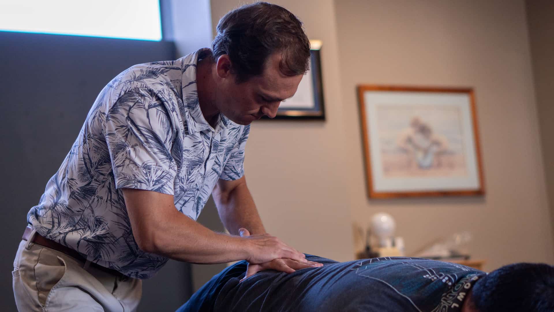 Dr. Riley Miller using the lumbar drop piece on the treatment table