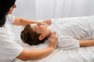 Chiropractor providing gentle adjustment to child patient