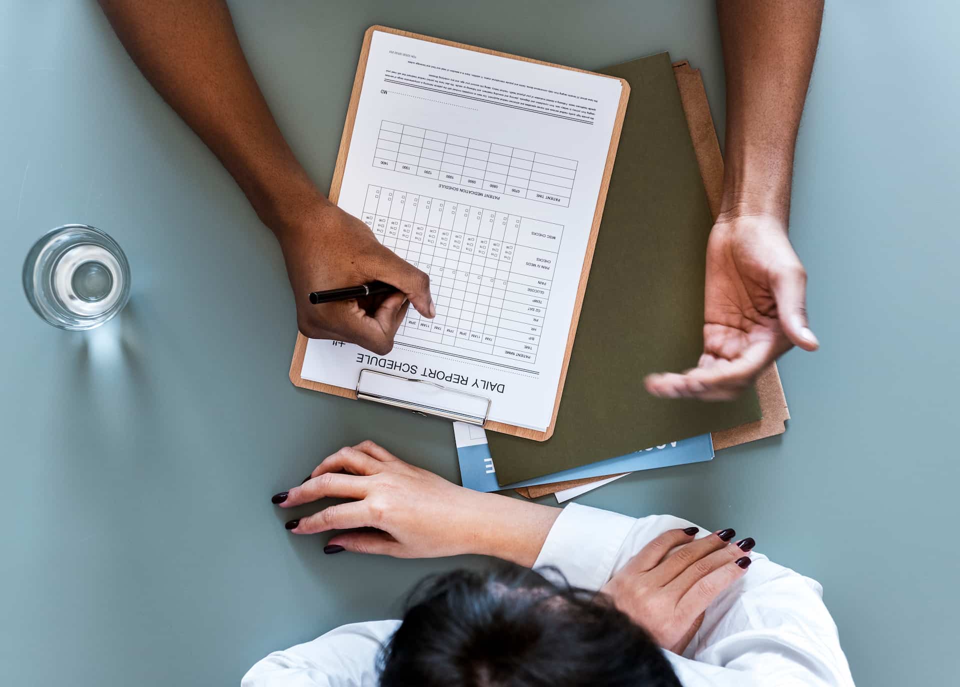 Patient filling out a chiropractic intake form during an initial consultation
