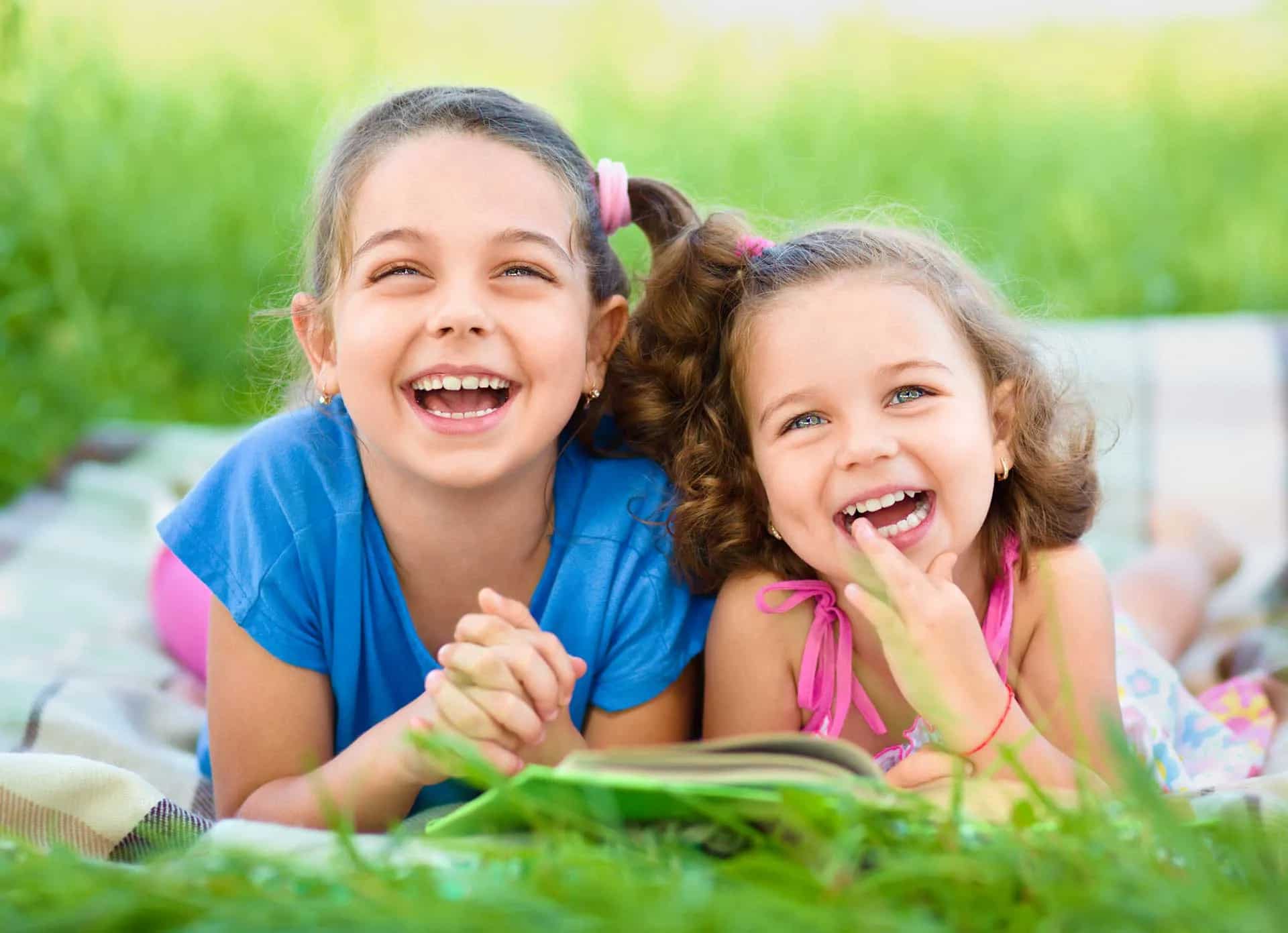 Smiling children playing outdoors after chiropractic care