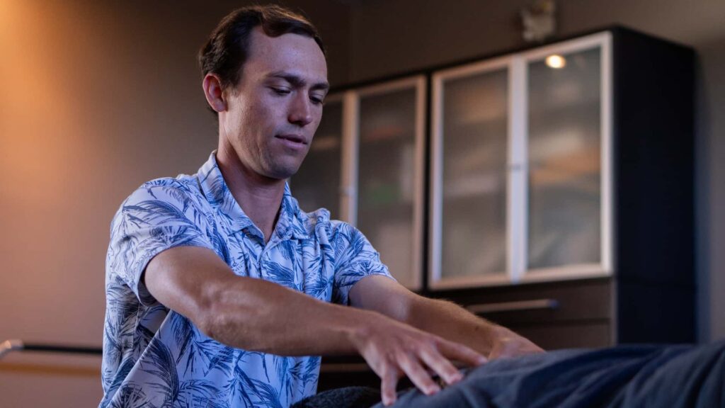 Dr. Riley Miller using the ArthroStim chiropractic instrument