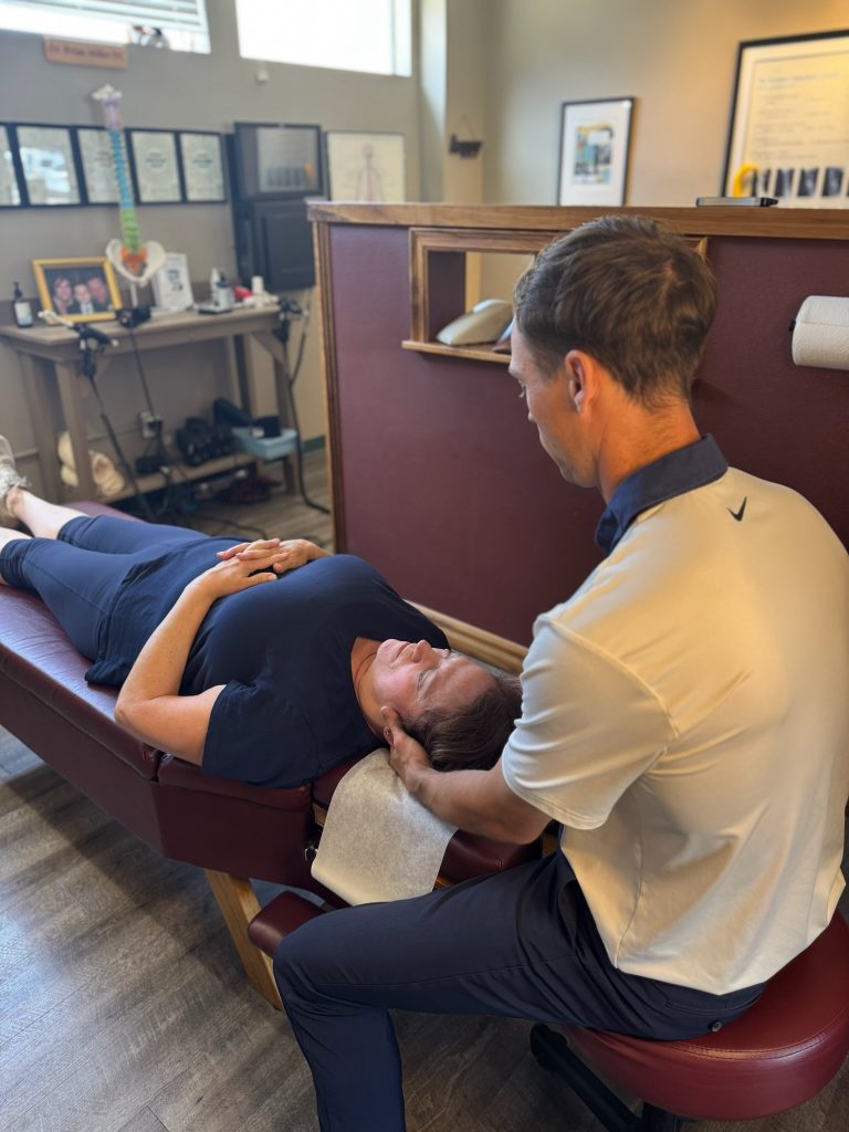 Dr. Riley Miller deliveringa controlled lumbar thrust