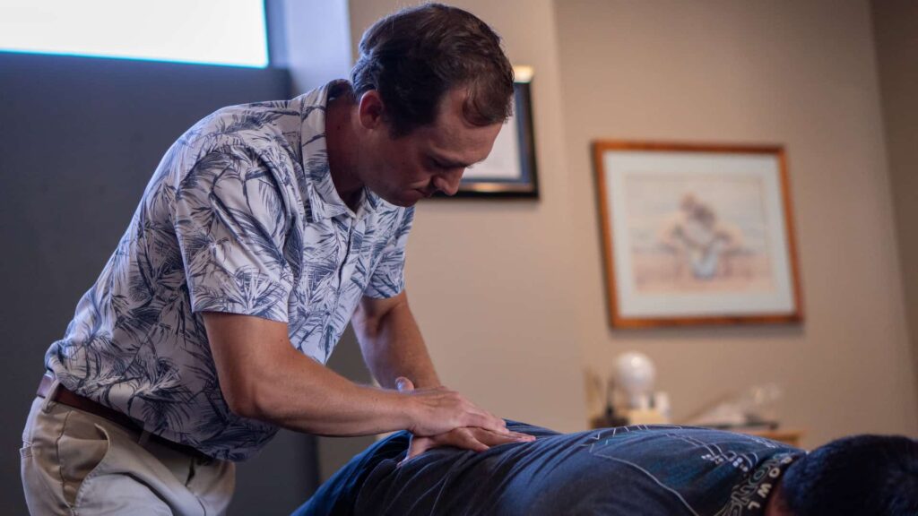 Dr. Riley Miller using the lumbar drop piece on the treatment table