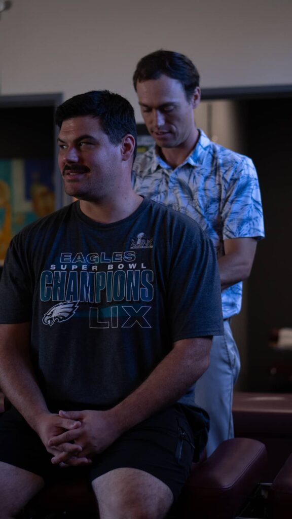 Dr. Riley Miller is adjusting the patient's rib and mid-back
