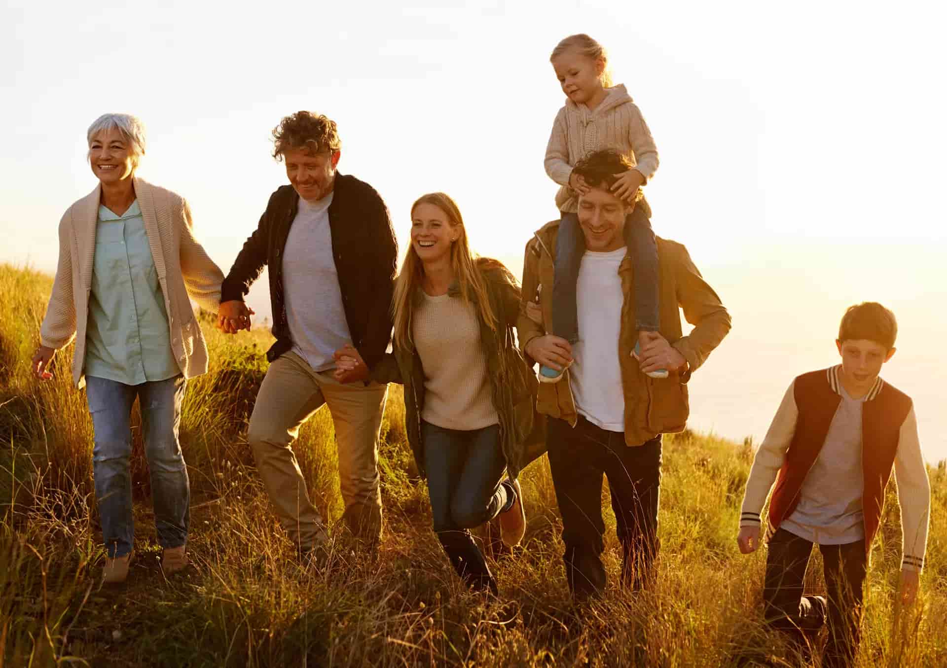 Family walking together outdoors representing experience, expertise, and family-centered chiropractic care