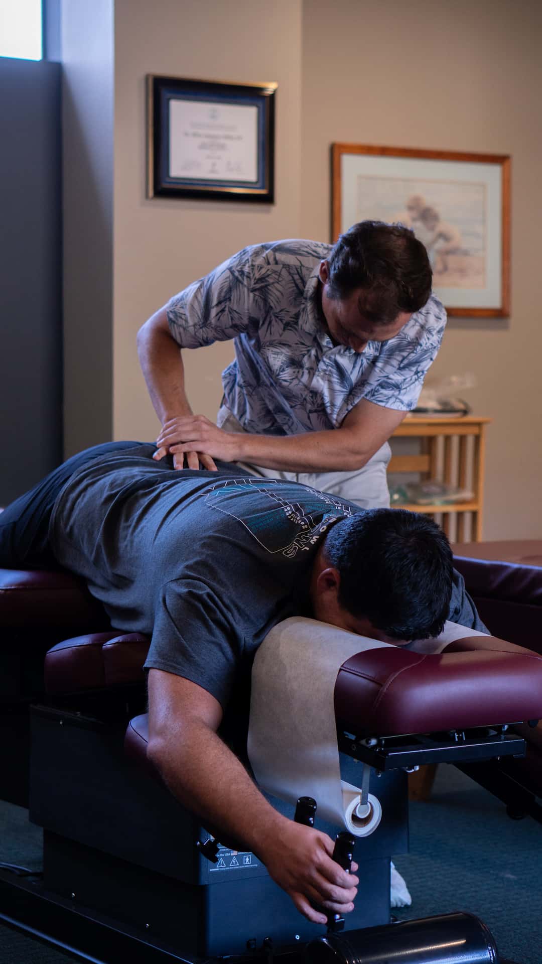 Relaxed patient on modern drop table during Dr. Riley Miller's adjustment