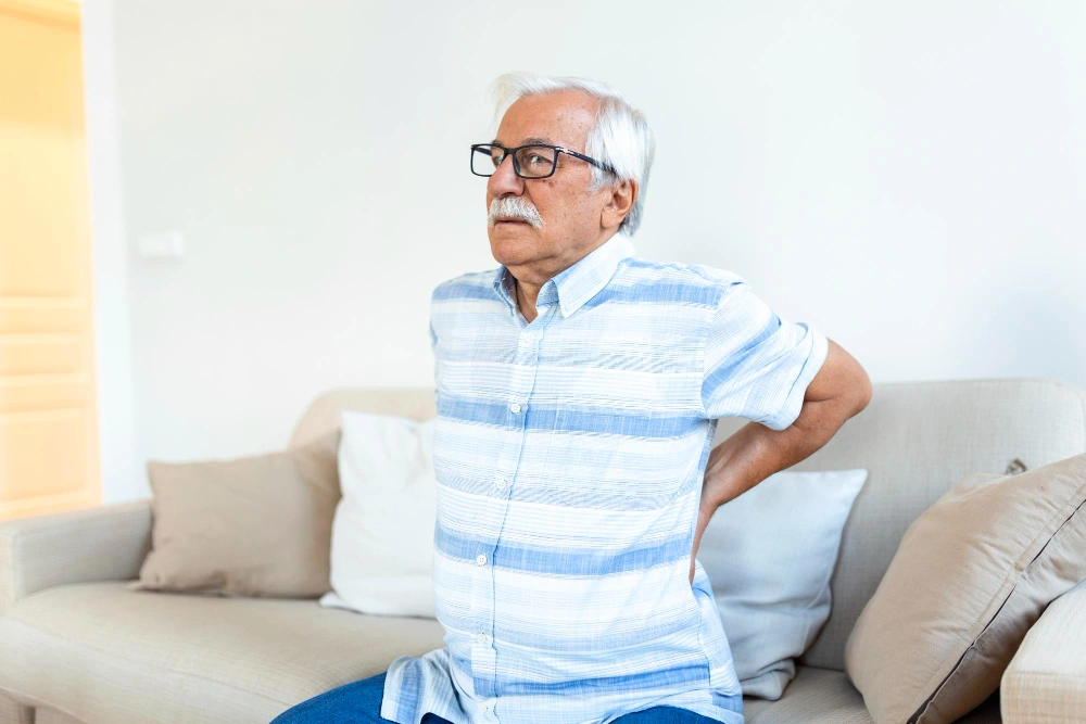 Senior man experiencing herniated disc back pain